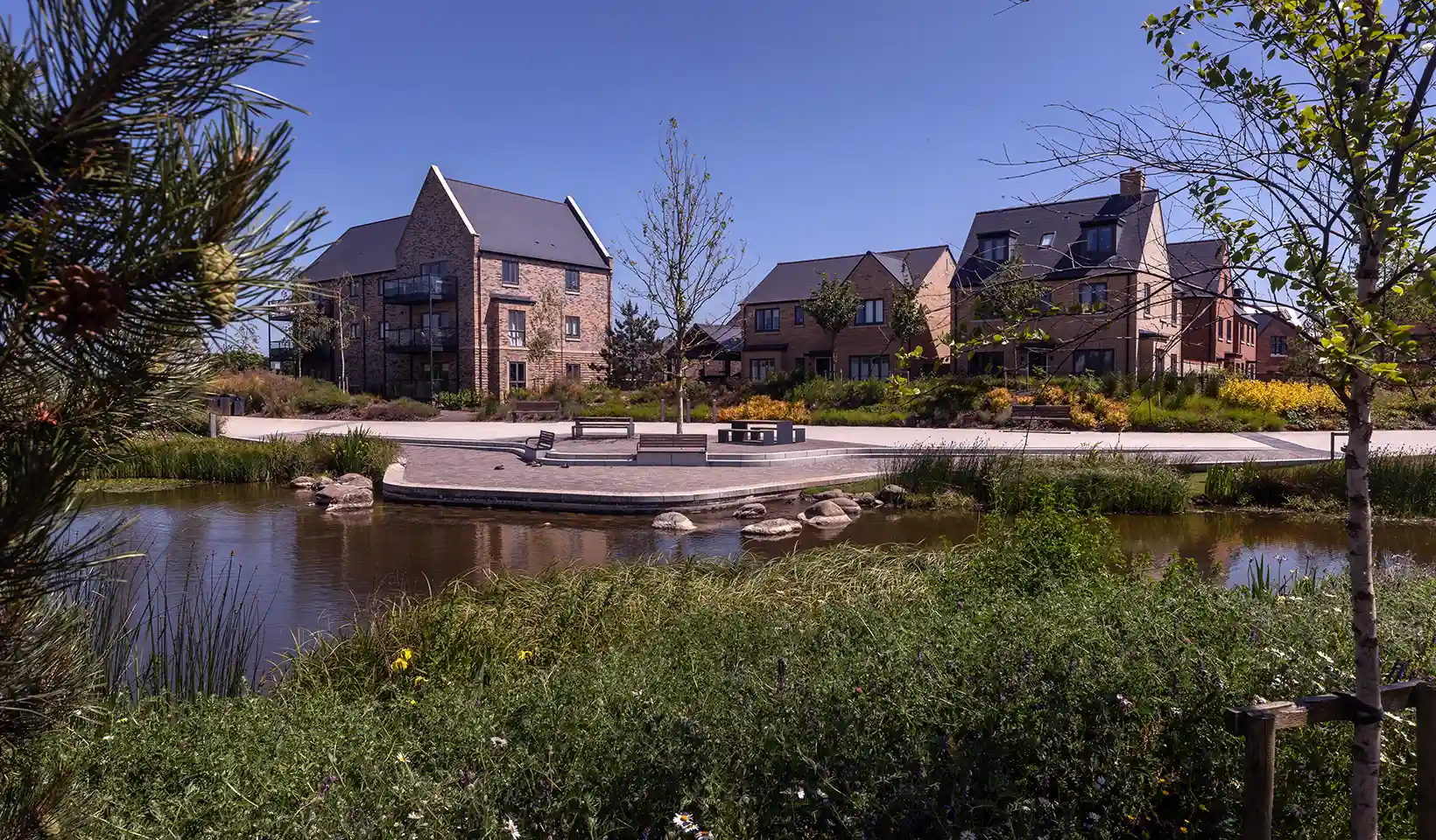 New homes overlooking Bret Pond at Wintringham St Neots