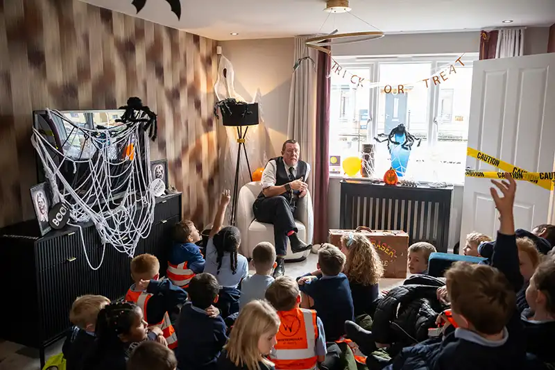Mark Fraser telling a Halloween story to pupils of Wintringham Primary Academy