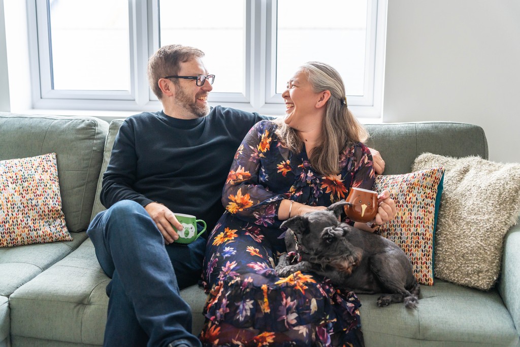 Family laughing on sofa in Wintringham