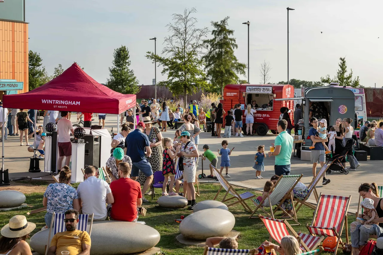 Pop-Up Food event Wintringham showing people sat eating food and vendors selling street food